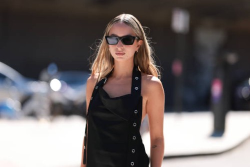 Isabelle Allain is seen wearing black angular cat-eye shaped sunglasses from the Gentle Monster x Jentle Salon collection; small silver hoop...