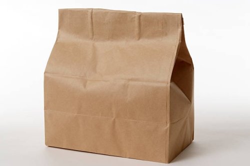 isolated shot of closed brown paper bag on white background - junk food stock pictures, royalty-free photos & images