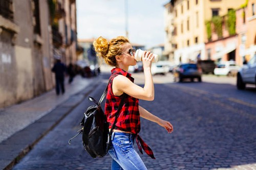 italy, verona, woman drinking coffee to go in the city - junk food stock pictures, royalty-free photos & images
