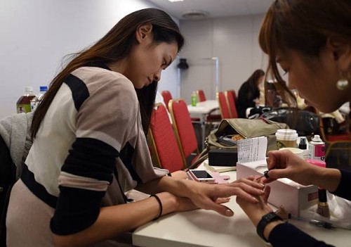Japan-fashion-lifestyle-model,FEATURE by Alistair Himmer Japanese fashion model Rei Hamada checks previous year's movie while receiving a nail care...