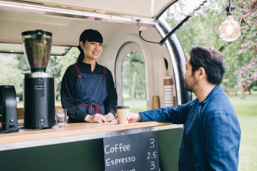 japanese customer and mobile coffee trailer owner having a chat - junk food stock pictures, royalty-free photos & images