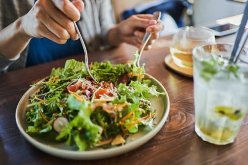 japanese woman eating a vegan lunch at a vegan cafe - food stock pictures, royalty-free photos & images