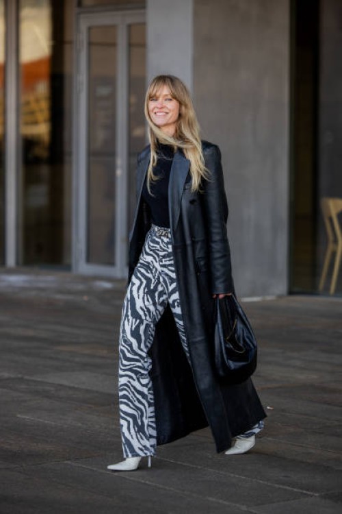Jeanette Friis Madsen wears black leather coat, zebra print pants, black bag outside OpéraSport during the Copenhagen Fashion Week AW24 on January...