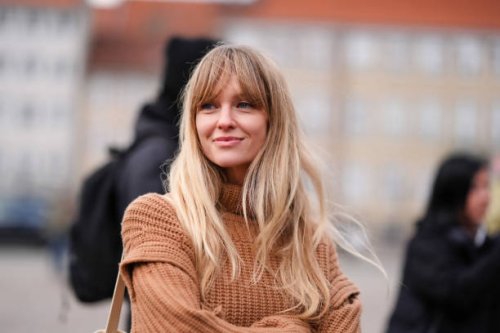 Jeanette Madsen wears a brown ribbed wool pullover with turtleneck , outside Wood Wood, during the Copenhagen Fashion Week AW24 on January 31, 2024...