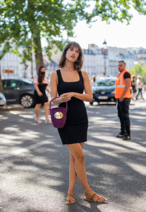 Jeanne Damas seen wearing black dress, purple straw bag outside Patou during Paris Fashion Week on July 03, 2022 in Paris, France.