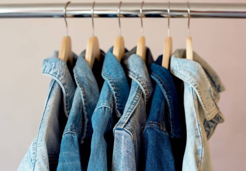 jeans jackets and retro shirts on second hand market / flea market - fashion stock pictures, royalty-free photos & images