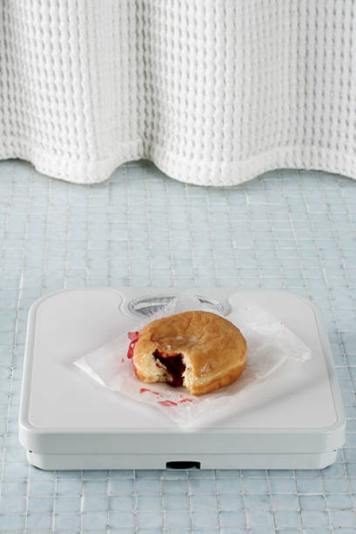 jelly donut on a bathroom scale - junk food stock pictures, royalty-free photos & images