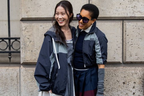 Jenny Tsang wears grey jacket, wrapped jumper & Tamu McPherson wears jackets, gauntlets, sunglasses outside Miu Miu during the Womenswear Fall/Winter...