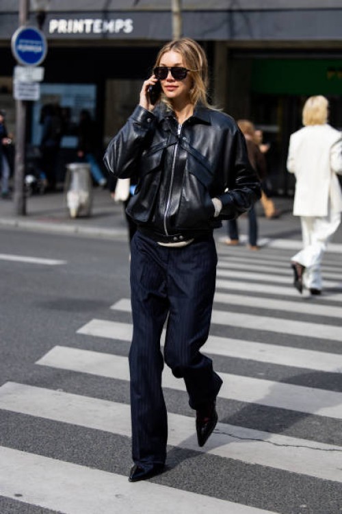 Jessie Andrews wears black leather jacket, navy pants, sunglasses outside Magda Butrym presentation during the Womenswear Fall/Winter 2025/2026 as...