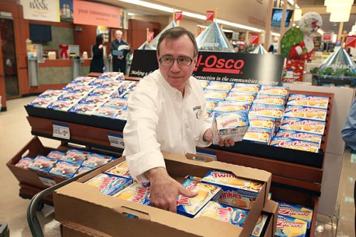 John Kolton stocks a display of Hostess snacks at a Jewel-Osco grocery store on December 11, 2012 in Chicago, Illinois. The Jewel-Osco grocery store...