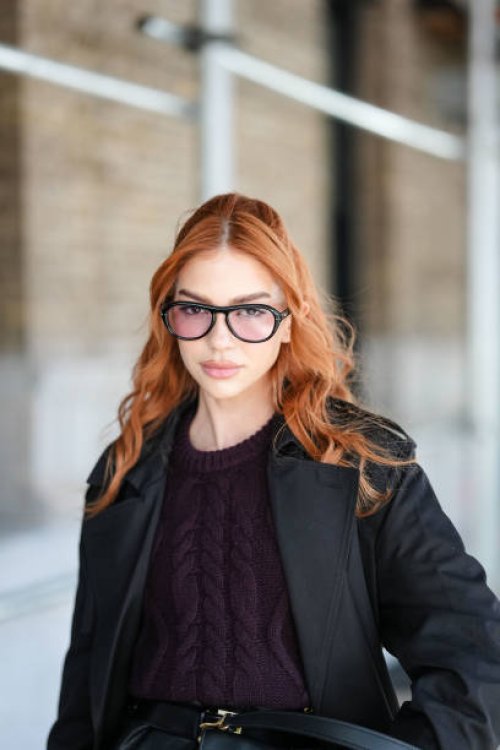 Jordanna Maia wears black sunglasses, dark brown sweater, black trench coat,outside Coach, during the New York Fashion week Fall/Winter 2025 on...