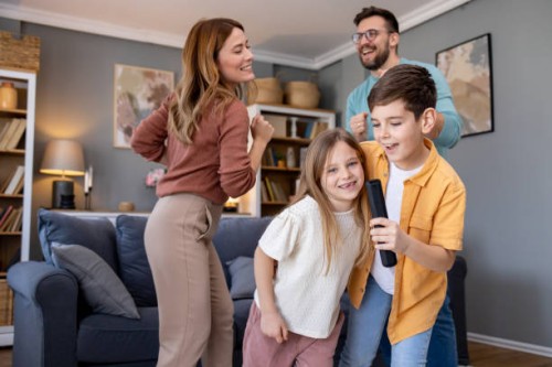 joyful karaoke singing with family at home - concert stock pictures, royalty-free photos & images