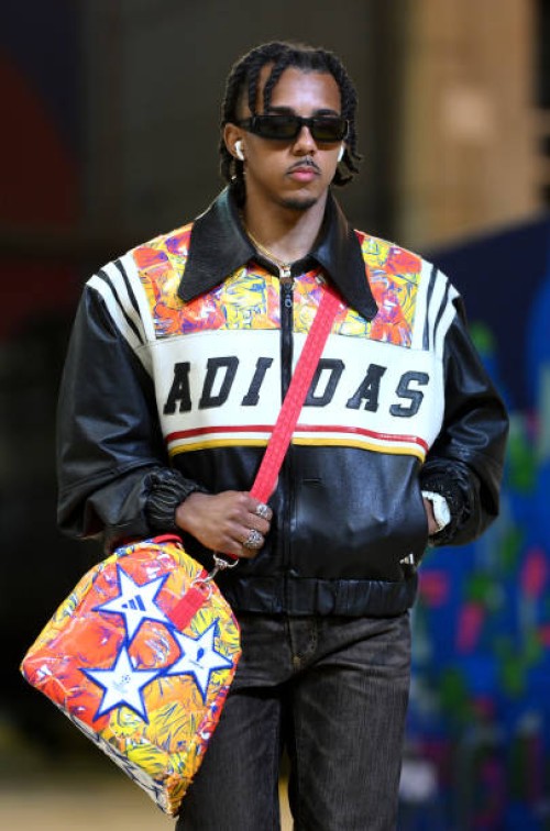Jules Kounde of FC Barcelona arrives at the stadium wearing a collection of clothes and accessories fashioned from the UEFA Champions League official...