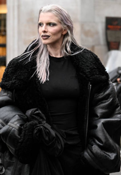Julia Fox is seen wearing a black faux leather black trim coat, black skirt outside the Vetements show during the Womenswear Fall/Winter 2024/2025 as...
