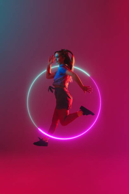 jumping through a neon hoop - fashion stock pictures, royalty-free photos & images