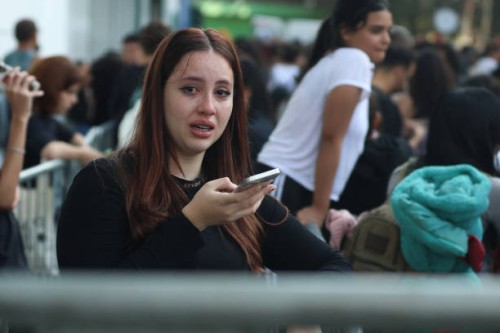 June 2023, Brazil, São Paulo: A young woman cries in front of the Allianz Parque stadium because she did not get tickets for "The Eras Tour" of...