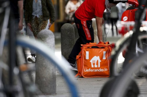 Just Eat Takeaway.com NV Lieferando.de food delivery cyclist collects a customer order in Berlin, Germany, on Monday, May 24, 2021. The online food...
