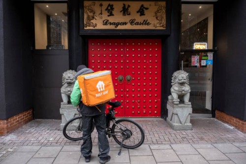 Just Eat takeaway delivery cycle courier outside the Dragon Castle Chinese restaurant on 7th January 2024 in London, United Kingdom. Just Eat acts as...
