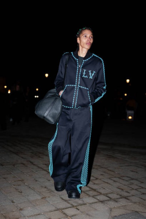 Kai-Isiaiah Jamal wears an all blue sportswear outfit, a sweater, striped track pants / jogger pants, before the Louis Vuitton Menswear Fall-Winter...