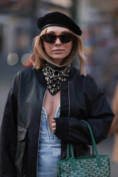 Karin Teigl seen wearing Celine brown sunglasses, Gucci black beret hat, H&M Studio light blue sleeveless denim / jeans long dress, Edited black...