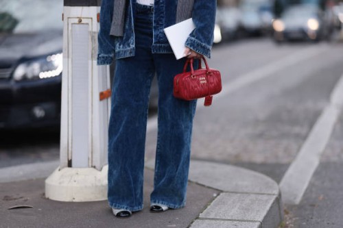 Karin Teigl seen wearing Miu Miu grey cable wool knit sweater, Miu Miu blue corduroy jacket, matching Miu Miu blue corduroy wide leg pants, Miu Miu...