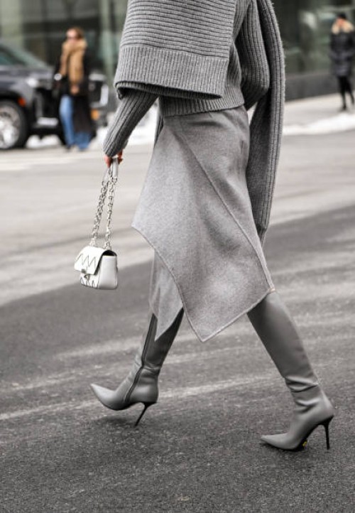 Kate Bartlett is seen wearing a gray Michael Kors Collection sweater, skirt and knee high boots with white chain bag outside the Michael Kors show...