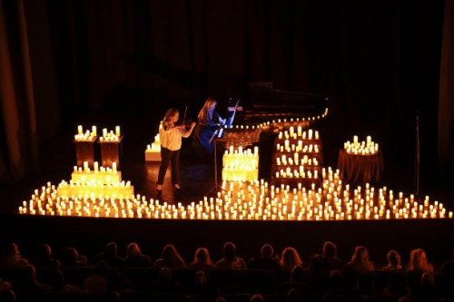 Katerina Boichuk on violin and Olena Zhukova on piano perform during Light classics by candlelight at the Architect's House organised by Svitlo...
