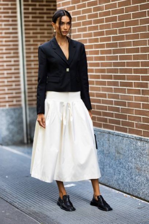 Kelly Gale is seen wearing a white wide skirt and short black blazer outside Fendi show during the Milan Fashion Week - Womenswear Spring/Summer 2024...