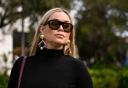 Kelly Hughes is seen wearing a black Nanushka dress, black sunglasses, burgundy bag and silver earrings on December 05, 2024 in Miami, Florida.