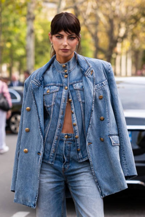 Kelly Piquet wears a blue denim shirt with matching blazer and wide leg jeans, outside Zimmermann, during the Womenswear Spring/Summer 2024 as part...