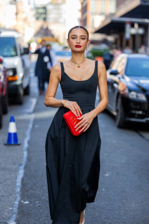 Kelsey Merritt wears black dress, red bag outside Carolina Herrera on September 12, 2023 in New York City.