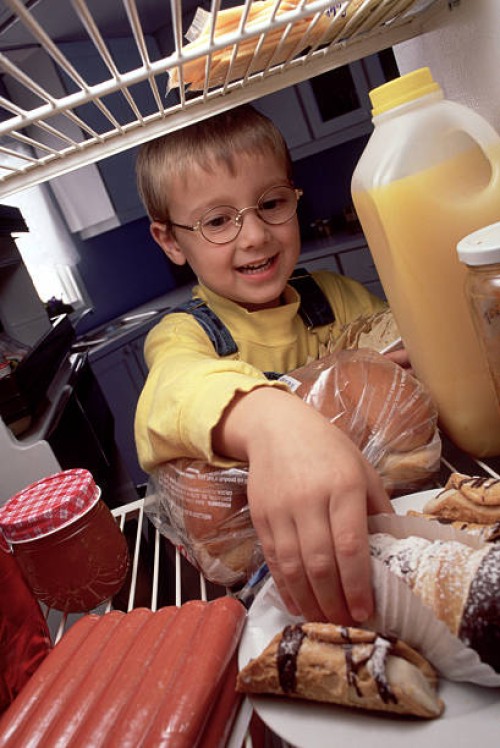 kid in the fridge - junk food stock pictures, royalty-free photos & images