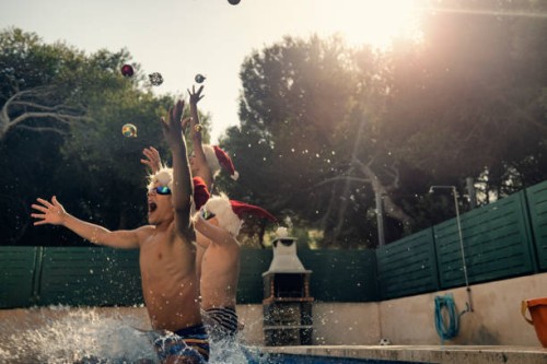 kids jumping into swimming pool on summer christmas - garden decoration stock pictures, royalty-free photos & images