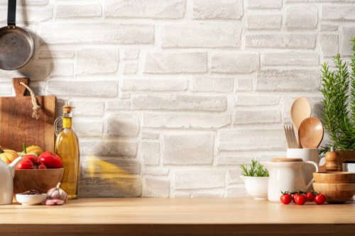 kitchen countertop with utensils, vegetables and spices on brick wall background. copy space available - food stock pictures, royalty-free photos & images