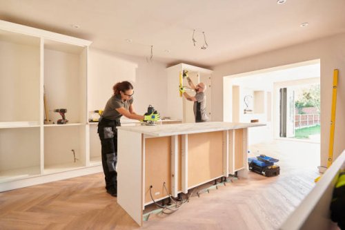 kitchen fitters installing some cabinets - home decoration stock pictures, royalty-free photos & images