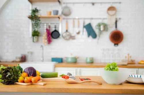 kitchen table with vegetables and cutting board for preparing salad . - food stock pictures, royalty-free photos & images