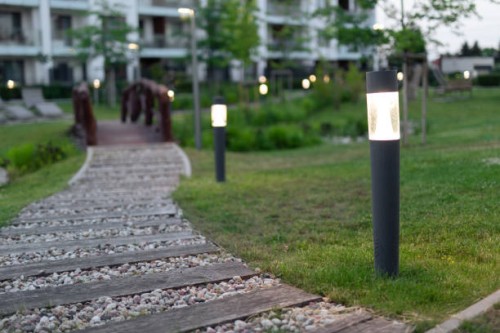 lamps by the footpath in an elegant courtyard at evening - garden decoration stock pictures, royalty-free photos & images
