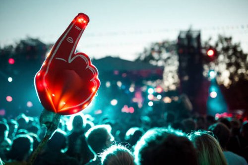 large foam hand over crowd of people having fun during music festival - concert stock pictures, royalty-free photos & images