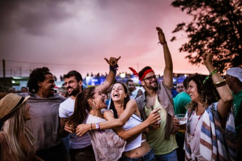 large group of cheerful friends dancing on an outdoor party. - concert stock pictures, royalty-free photos & images