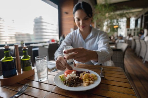 latin american woman enjoying a healthy meal at the hotel restaurant - food stock pictures, royalty-free photos & images