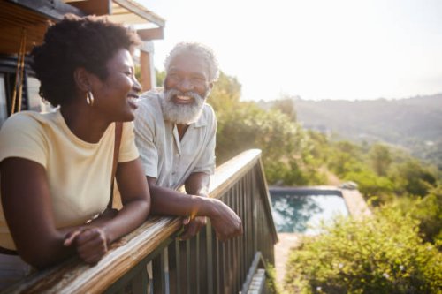 laughing couple standing on the balcony of their luxury vacation rental - travel stock pictures, royalty-free photos & images