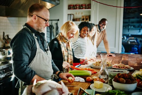 laughing friends taking cooking class in commercial kitchen - food stock pictures, royalty-free photos & images