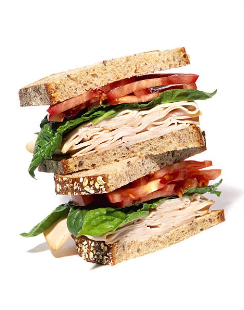 layered turkey sandwich with lettuce and tomato - food stock pictures, royalty-free photos & images