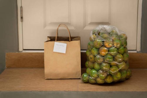 leaving paper bag with thai tangerine at front door - junk food stock pictures, royalty-free photos & images