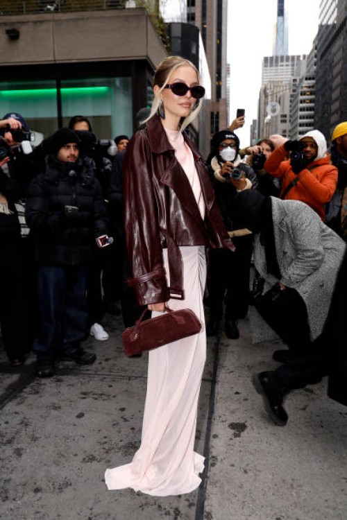 Leonie Hanne wearing a leather jacked long pink dress and bag arrives at the LaPointe show during New York Fashion Week on February 09, 2025 in New...