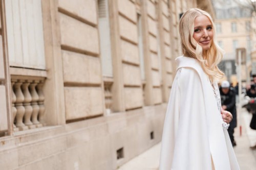 Leonie Hanne wears cream coat, outside Valentino, during the Womenswear Fall/Winter 2024/2025 as part of Paris Fashion Week on March 03, 2024 in...