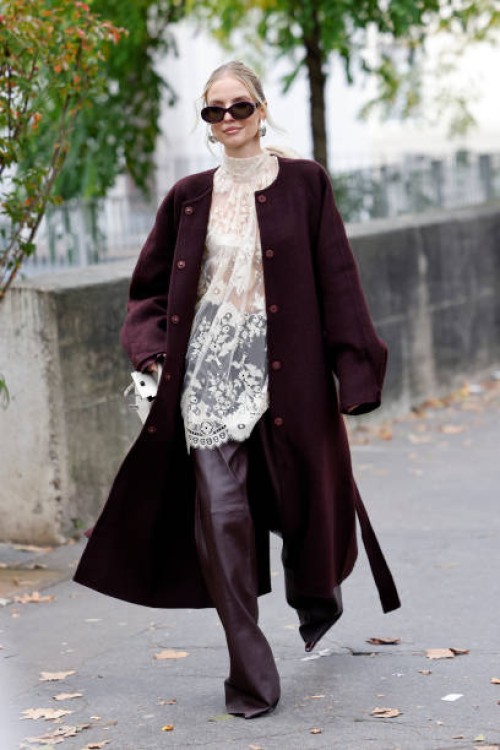 Leonie Hanne wears cream lace sheer blouse, burgundy leather pants, burgundy coat, white Hermes bag, burgundy Celine sunglasses, outside Zimmermann,...