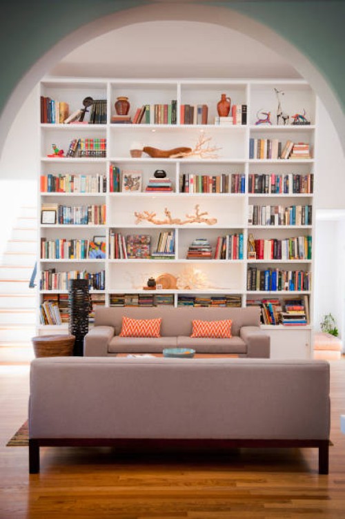 light-filled living room with tall bookshelves - home decoration stock pictures, royalty-free photos & images