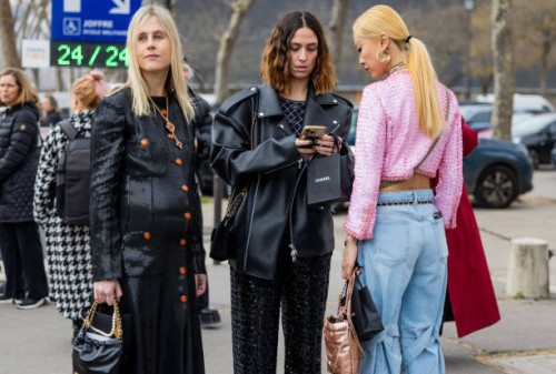 Linda Tol wears sequined black button up dress & Erika Boldrin wears black pants, leather jacket & Niki Wu Jie wears pink jacket, denim jeans outside...