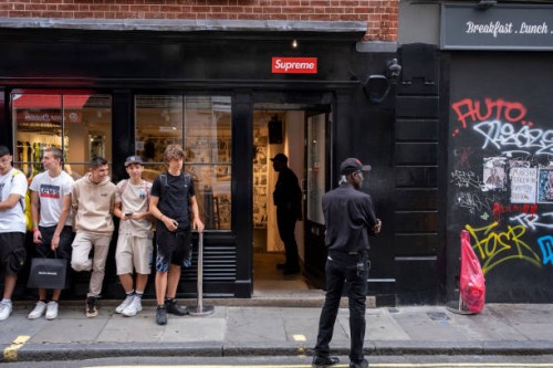 Line of young men queue up outside the Supreme store in Soho on 9th July 2023 in London, United Kingdom. Each week the fashion label Supreme, which...